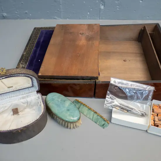 vintage writing slope box with alphabet stamps and pen nibs (some damage) and a small faux stone brush and comb set