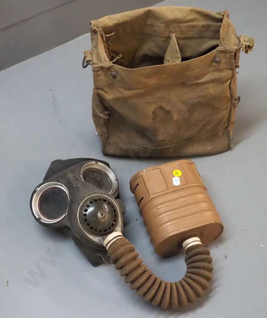 vintage gas mask in musty canvas bag Image 1++