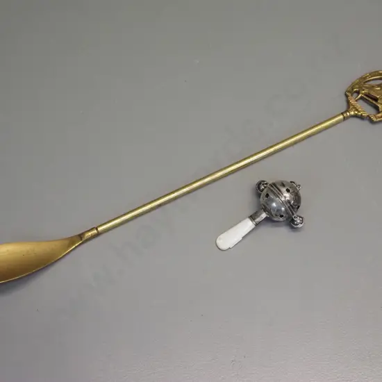 long handled brass shoe horn with horse motif L-500 and a silver (unmarked) baby's rattle with mother of pearl handle