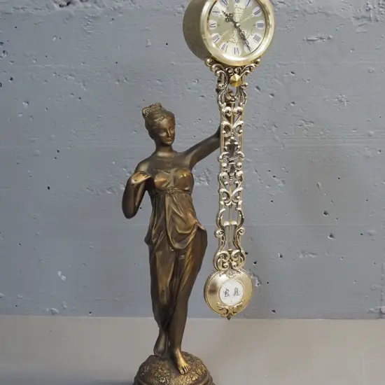 reproduction plastic and composite 'Rhythm' figural mystery clock H-490