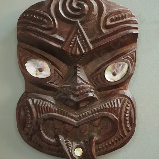 carved wooden wall-hanging tiki with paua shell insets H330 W230